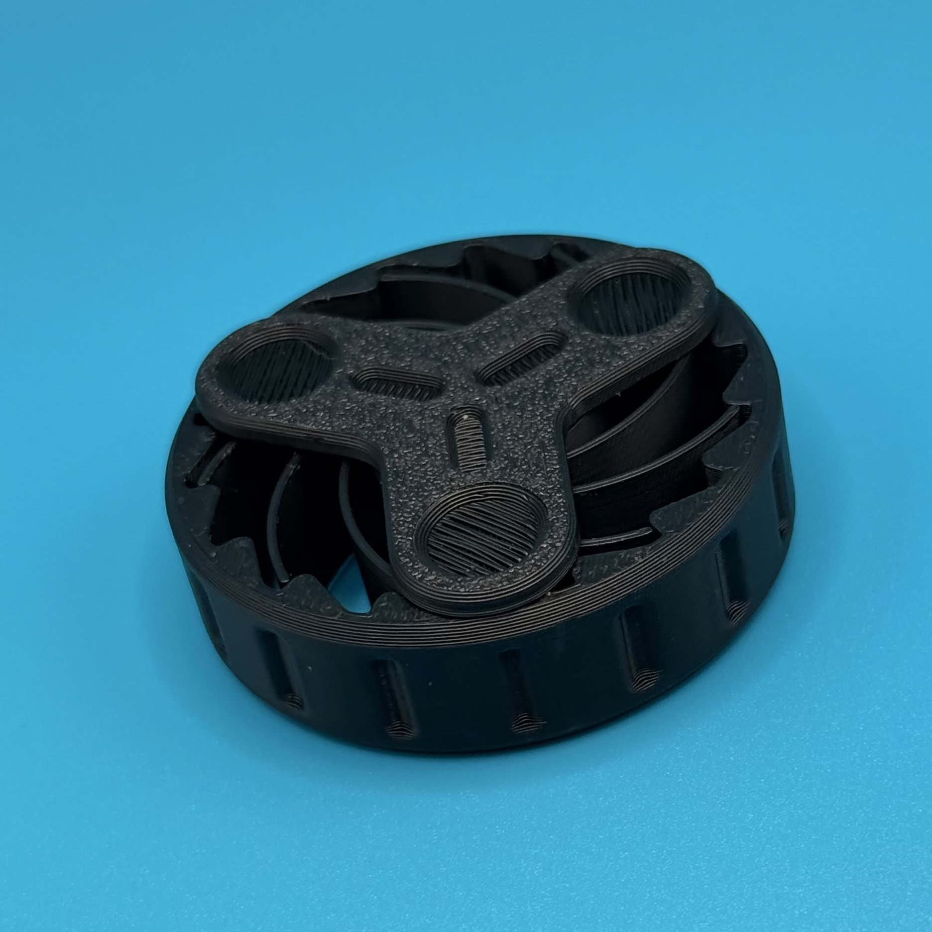 Black gear-edge fidget spinner